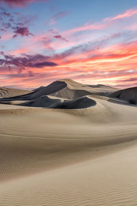 Scenic view of desert against sky during sunset