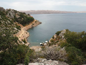 High angle view of sea and mountains against sky