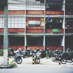 Bicycles parked on street against buildings in city