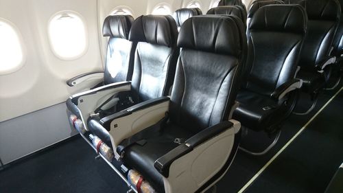 Empty black seats in airplane