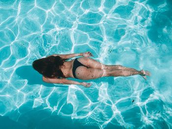 High angle view of woman swimming in pool