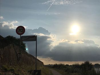 Low angle view of road sign against sky