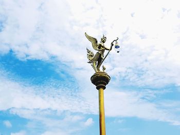 Low angle view of statue against blue sky