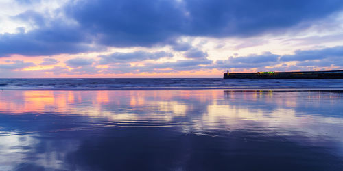 Scenic view of sea against sky at sunset