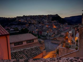 High angle shot of townscape against sky at dusk