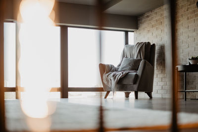 Man sitting on chair by table at home