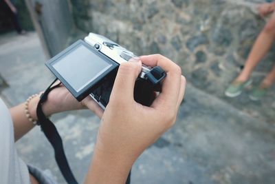 High angle view of woman holding camera