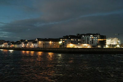 Illuminated city at waterfront