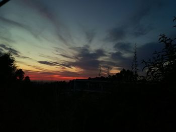 Silhouette landscape against sky during sunset