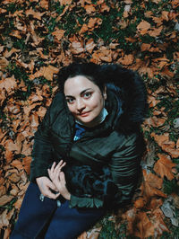 Portrait of beautiful woman with autumn leaves