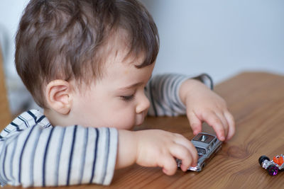 Little boy plaing with his toy cars