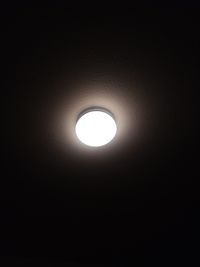 Low angle view of illuminated lamp at night