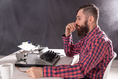 Young man sitting on table