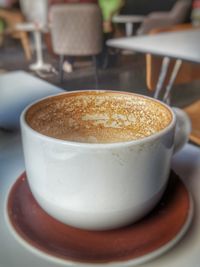 Close-up of coffee cup on table