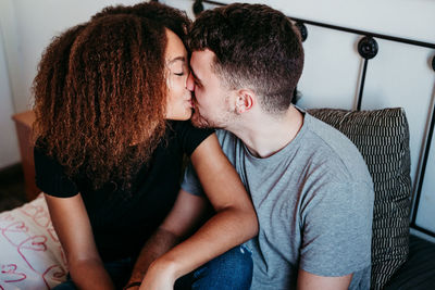 Midsection of couple sitting at home