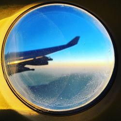 Close-up of airplane wing seen through window