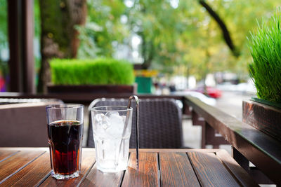 Summer drinks and ice lay on wooden table in the cafe