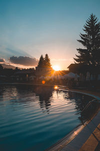 Scenic view of swimming pool against sky during sunset