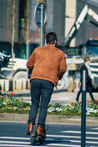 Rear view of man walking on street