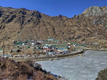 Scenic view of river amidst buildings against clear sky