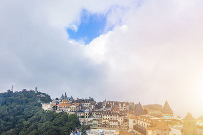 Buildings in town against sky