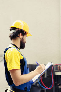 Rear view of man working at construction site