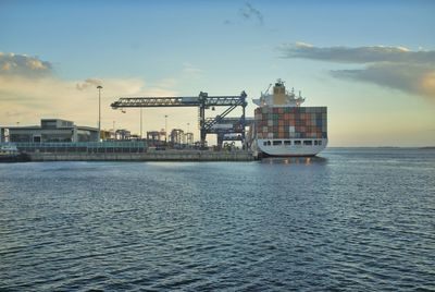 Cargo ship with a scenic view of sea against sky