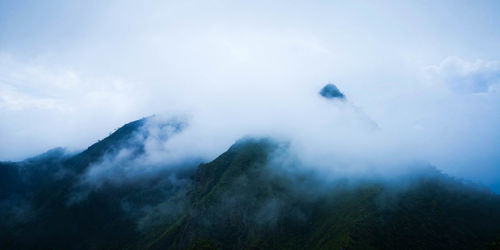 Scenic view of mountains in foggy weather