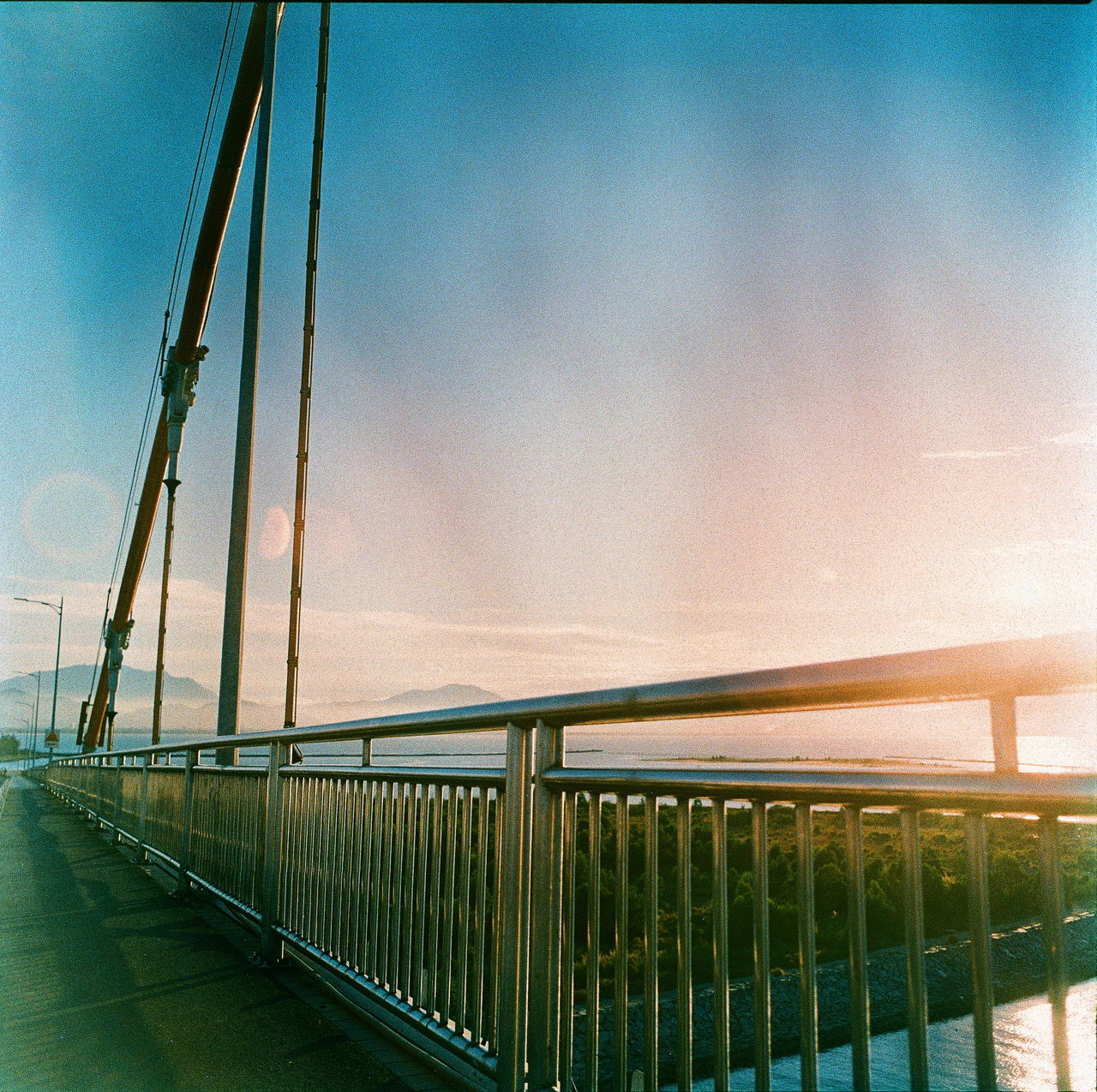 BRIDGE AGAINST SKY AT SUNSET