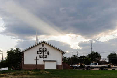 Road by building against sky