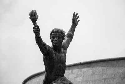 Low angle view of statue against sky