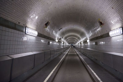 Empty illuminated subway tunnel