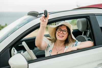 Portrait of young woman in car