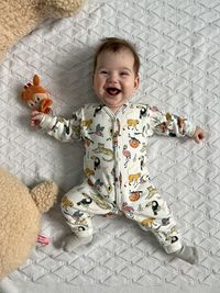 High angle view of cute girl playing with teddy bear