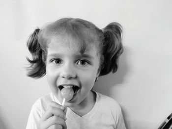 Portrait of girl eating lollipop