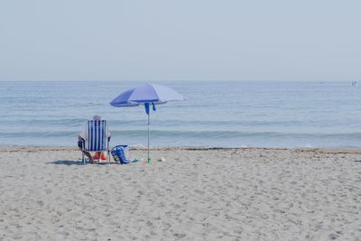 Lifeguard hut on beach against clear sky