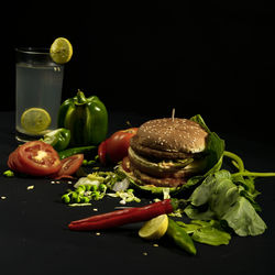 Close-up of fruits served on table against black background