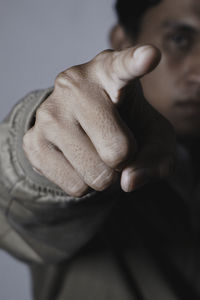 Cropped image of man pointing