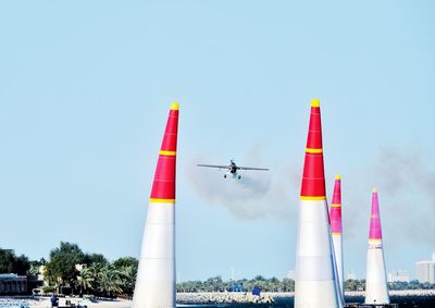 Low angle view of airplane flying against clear sky