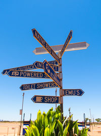 Low angle view of information sign against clear sky