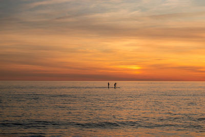 Scenic view of sea against orange sky