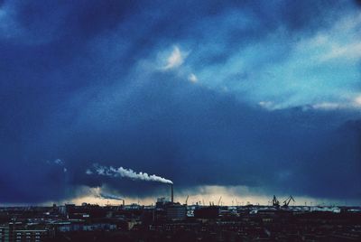 Cityscape against cloudy sky