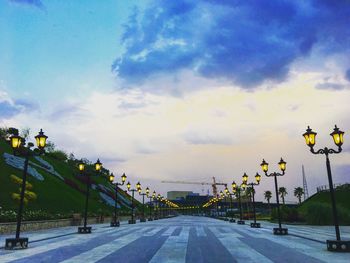 Empty road against sky in city