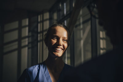 Sunlight falling on face of happy nurse in hospital