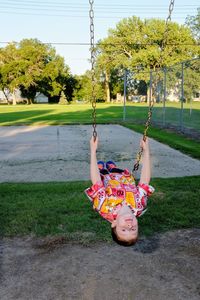 Boy swinging at playground