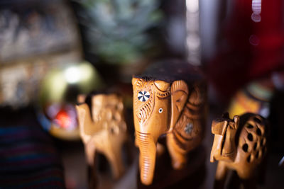 Close-up of elephant figurines on table at home