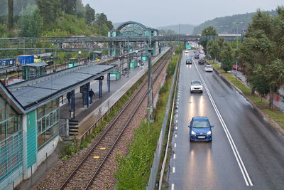 High angle view of railroad tracks amidst road in city