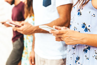 Midsection of woman using mobile phone