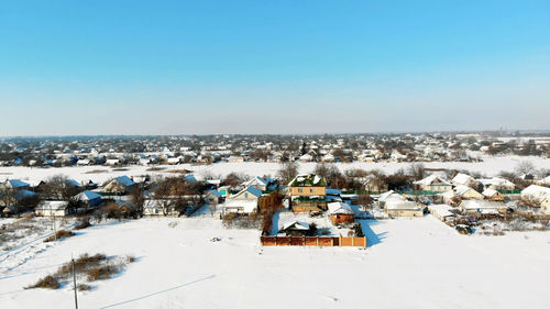 Winter, snow-covered streets, houses. frosty sunny day. aero, view from above.