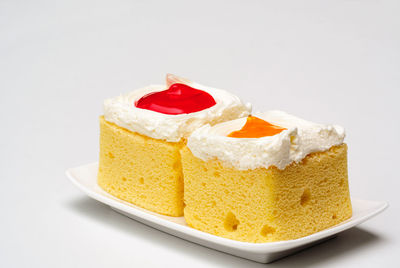 Close-up of cake slice over white background